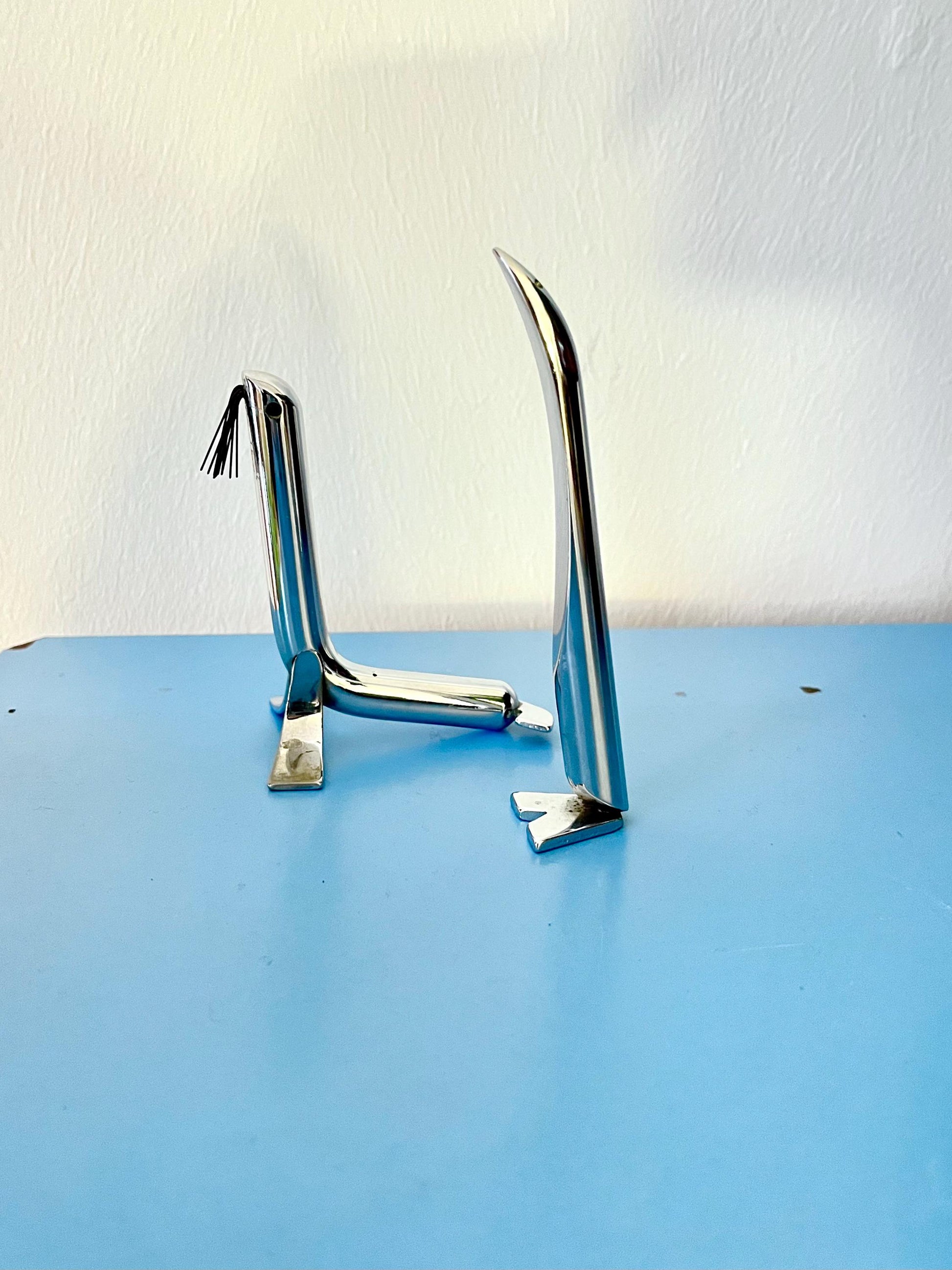 Vintage steel seal and penguin figurines, Italy 1970s, stylised steel seal and penguin figurines